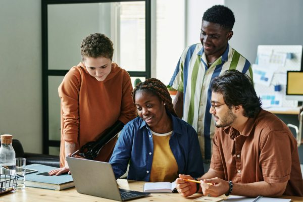 Group of intercultural employees listening to colleague